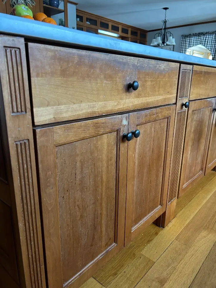 Worn cabinet finish showing thinning and dulling from daily use, before refinishing by Homestead Cabinet Design Palmer MA