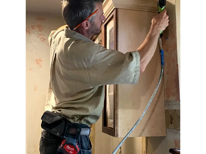 Crown molding added to upper cabinets during cabinet refacing to enhance kitchen appearance