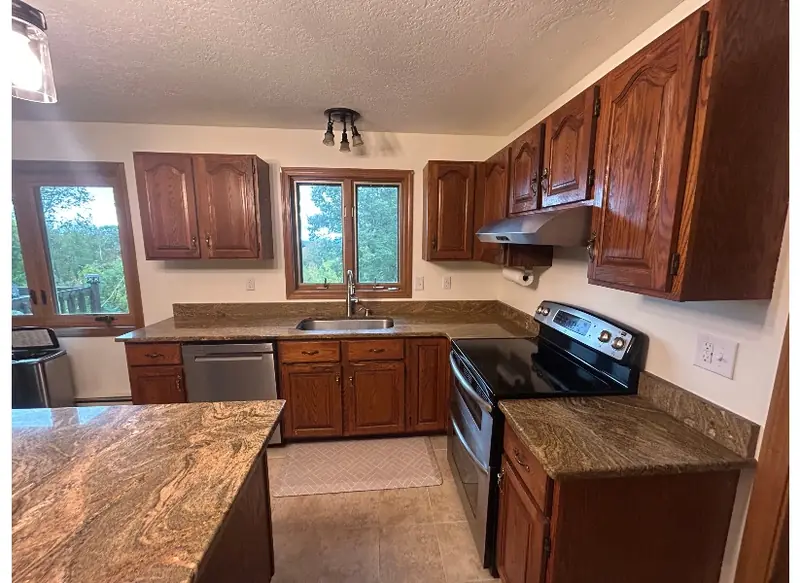 Dark outdated oak cabinets before kitchen cabinet refacing in Belchertown MA