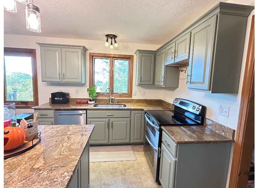 Sage green cabinet refacing completed in Belchertown Massachusetts kitchen by Homestead Cabinet Design
