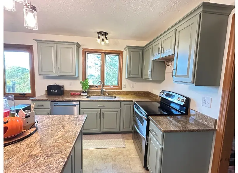 Sage green cabinet refacing completed in Belchertown Massachusetts kitchen by Homestead Cabinet Design