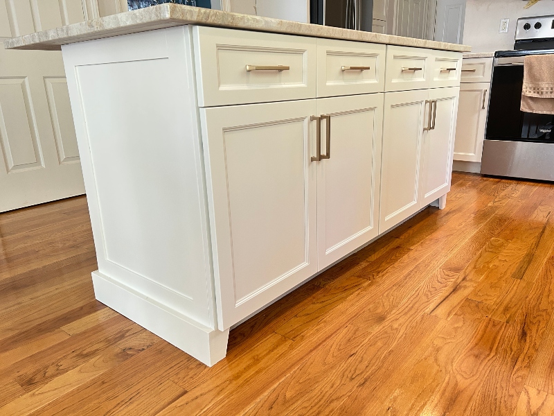Dark stained wood cabinet refacing on kitchen island with contrasting countertop