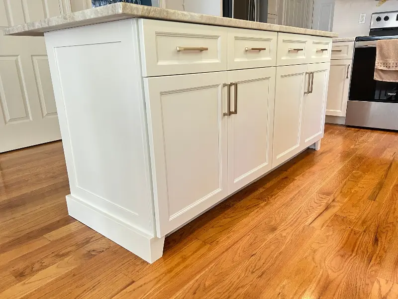Dark stained wood cabinet refacing on kitchen island with contrasting countertop