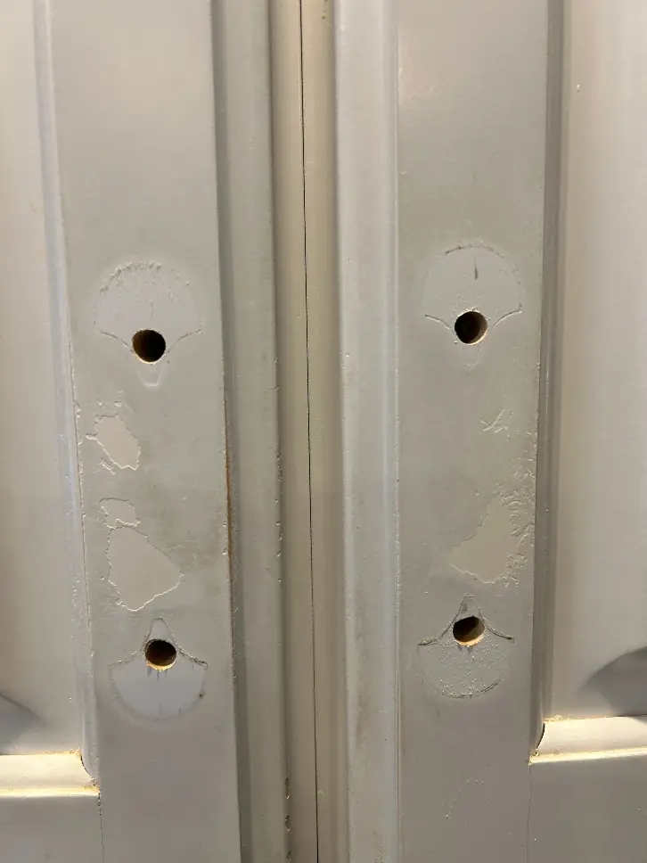 Oak cabinet door with finish worn away around the handle before refinishing — Homestead Cabinet Design Palmer MA