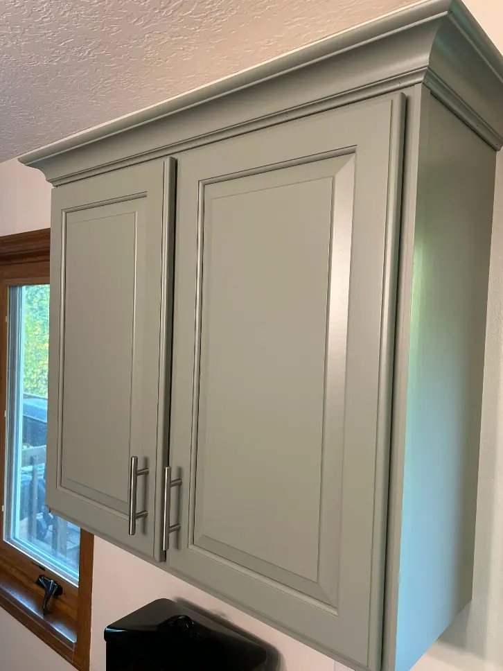 Benjamin Moore Evergreen Fog cabinet paint color applied over dark oak