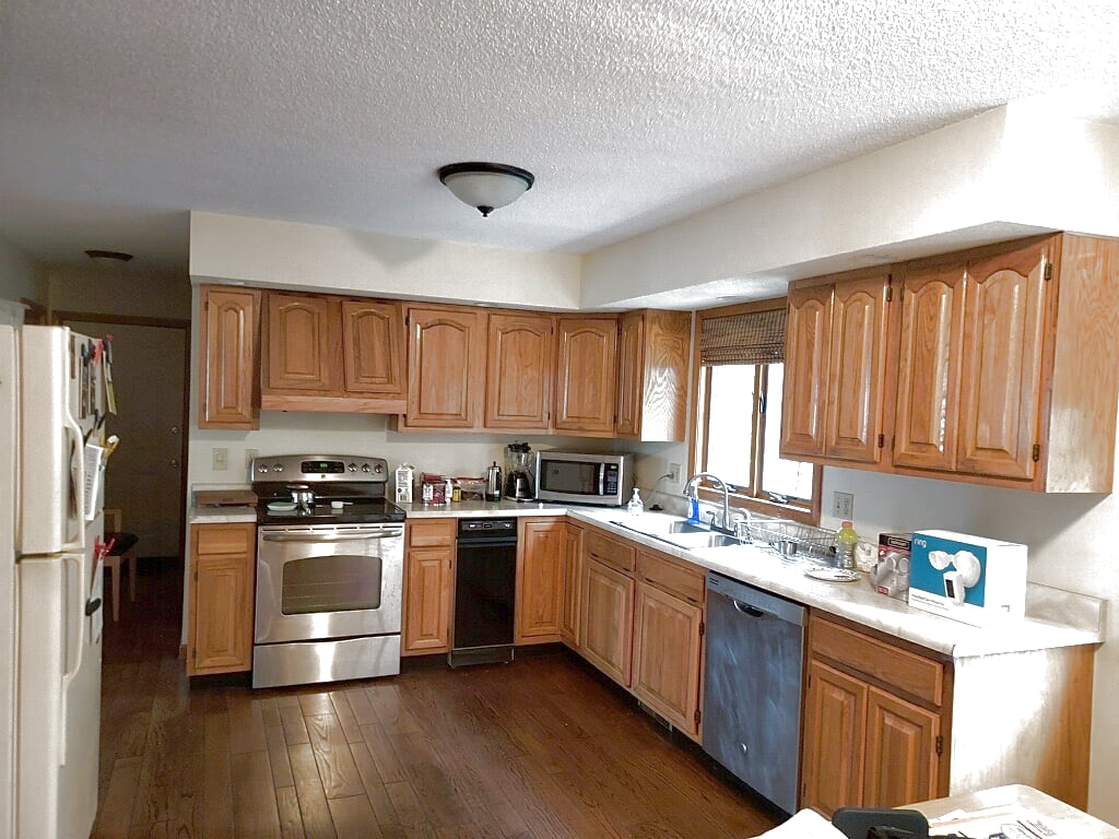 Honey oak cabinet before refacing in Chicopee MA — dated orange oak kitchen