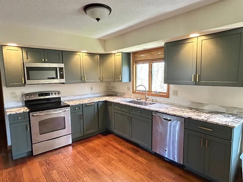 Honey oak cabinets refaced with green shaker doors in Chicopee Massachusetts kitchen
