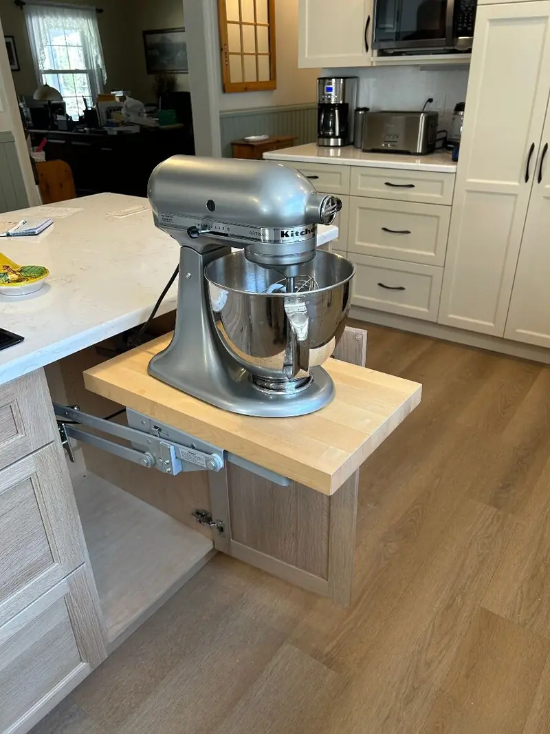 Pull-out butcher-block shelf holding a stand mixer