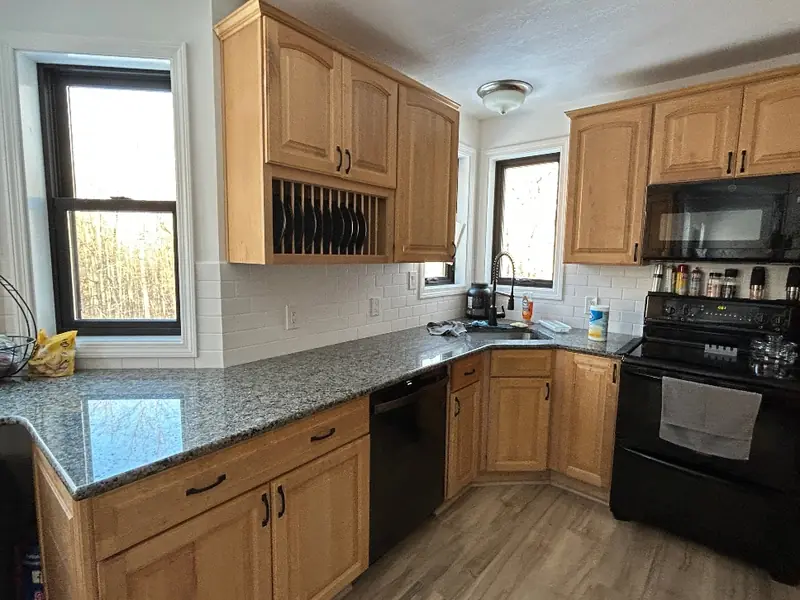 Maple kitchen cabinets before professional painting — dated oak-toned maple finish