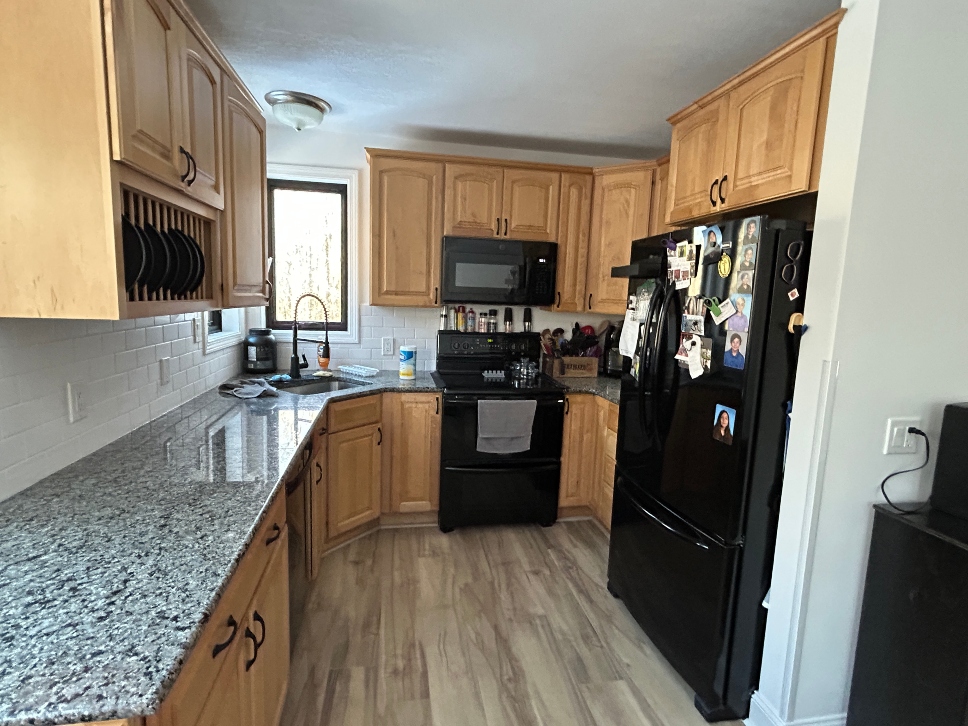Maple kitchen cabinets before painting — dated honey finish