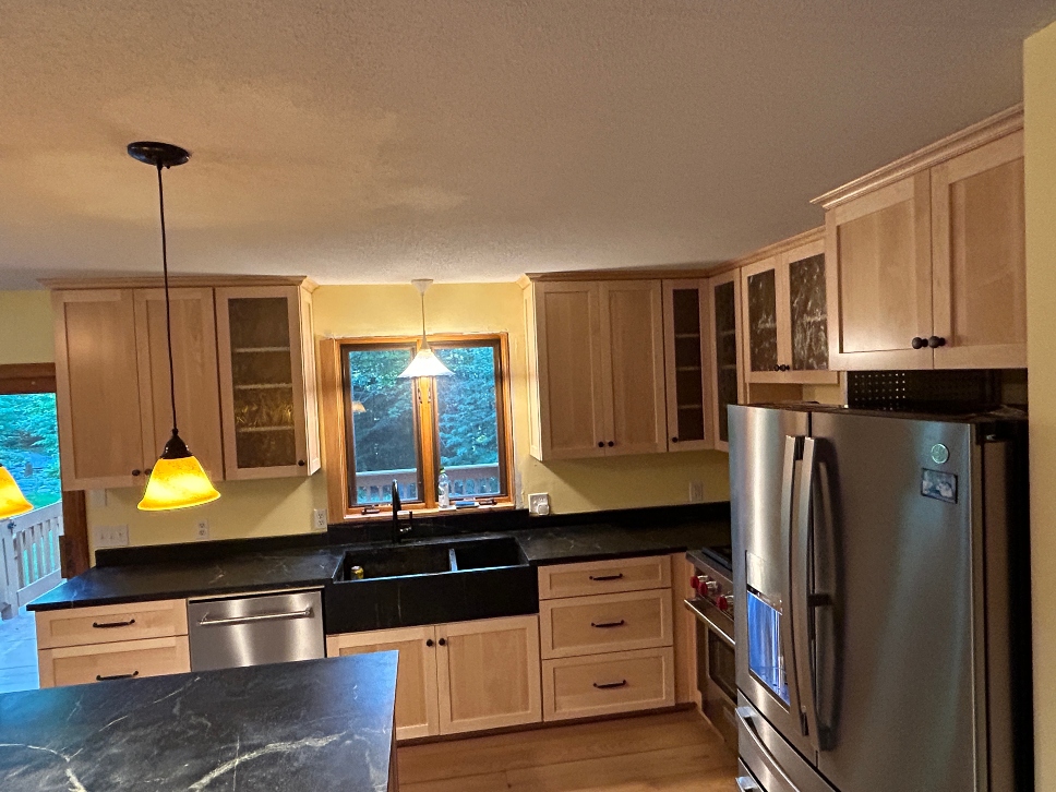 Natural maple cabinet refacing applied over existing oak kitchen cabinet boxes