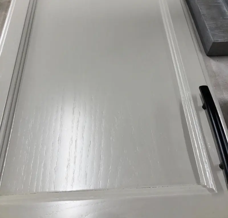 Oak cabinet door painted showing grain texture — grain still visible after standard painting process