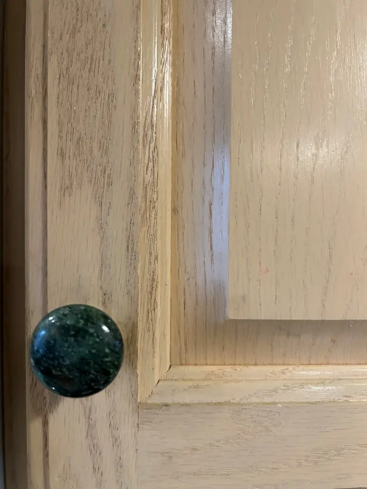 Oak cabinet grain texture before painting — open grain wood showing through paint primer