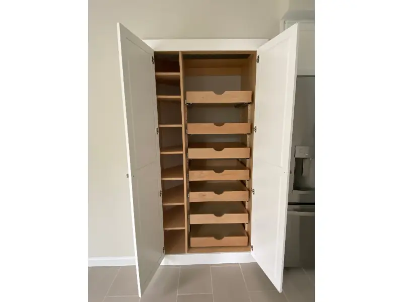 Floor-to-ceiling custom pantry cabinet with pull-out shelves — Massachusetts kitchen remodel