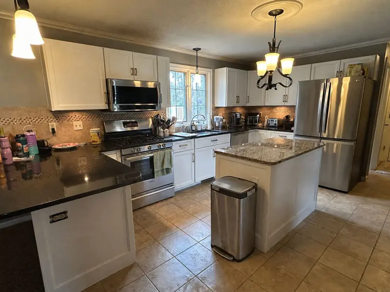 Kitchen with a freestanding trash can in the middle of the floor