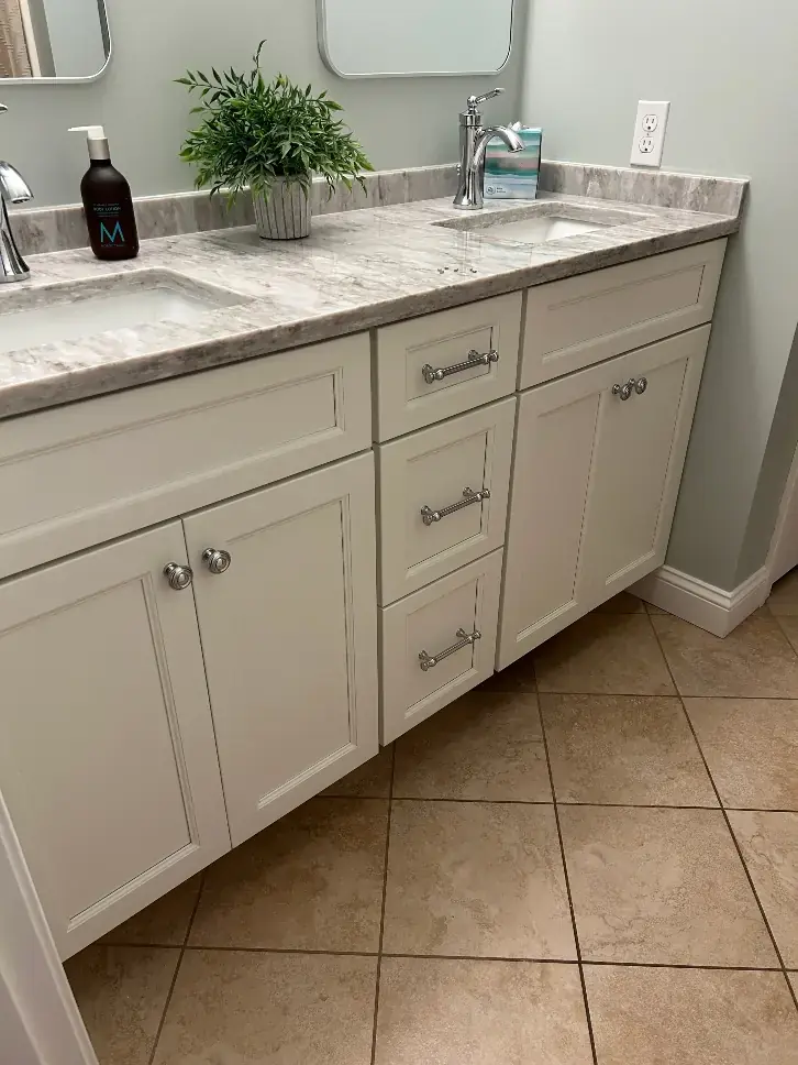 White double bathroom vanity with a marble-look top