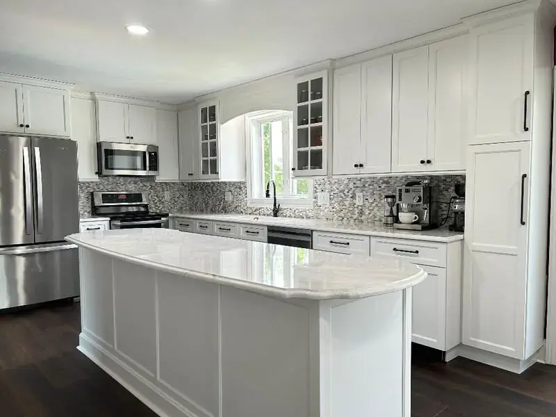 White kitchen with a curved marble-top island