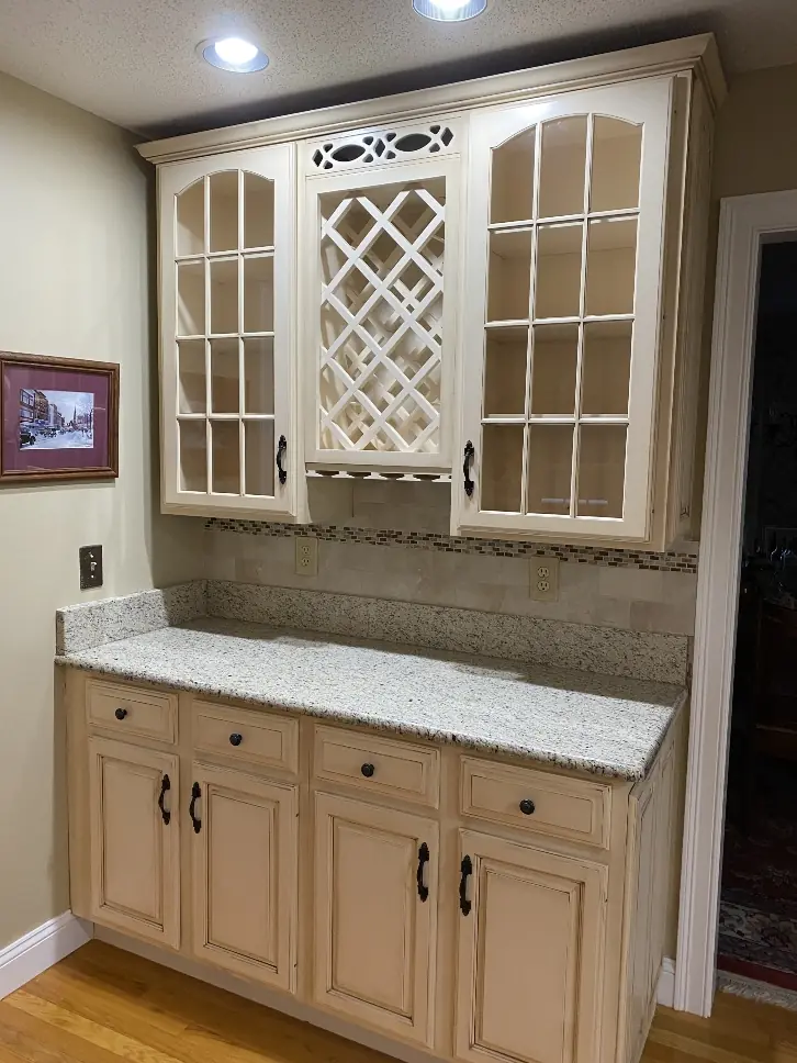 White painted kitchen cabinets with decorative brown glaze finish
