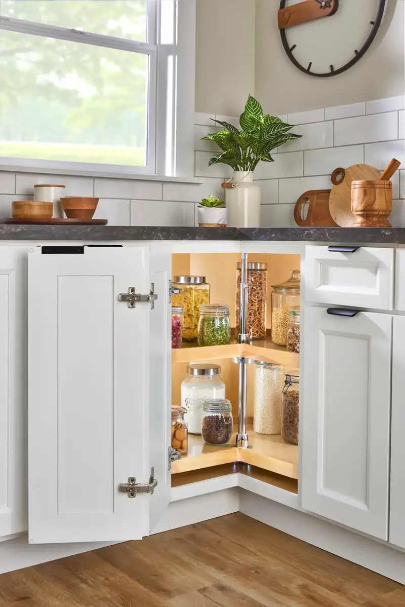 Wood kidney-shaped lazy Susan in a corner cabinet